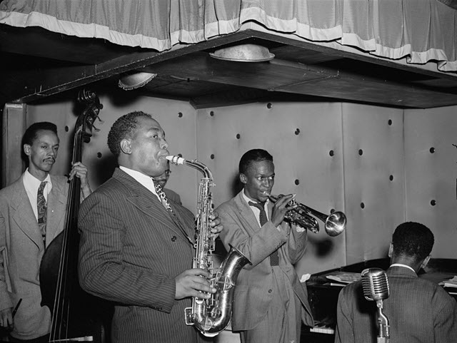An image of Miles Davis and Charlie Parker performing together